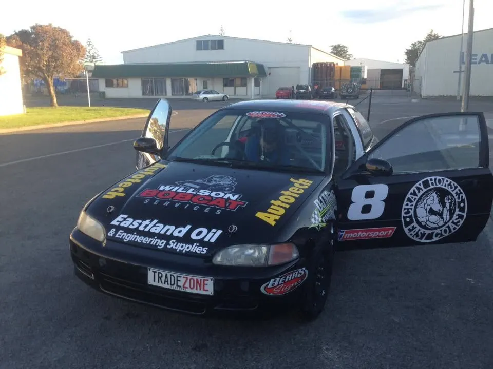 The number 8 Civic in Autotech colours parked outside the workshop